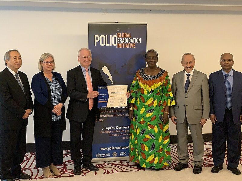 Members of the global certification commission holding the signed certificate of wild poliovirus type 3 eradication, October 2019