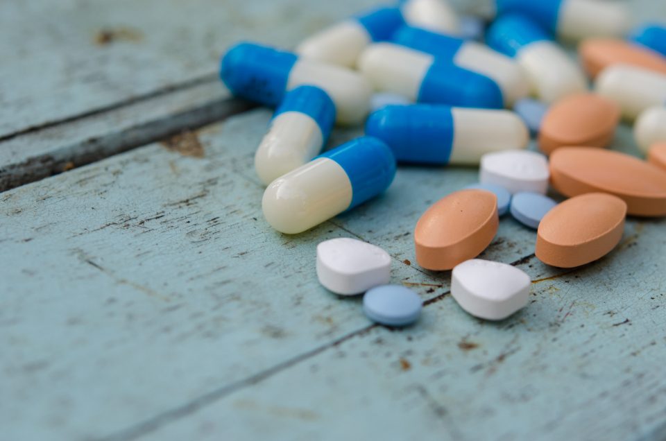 Capsules scattered on a wooden table