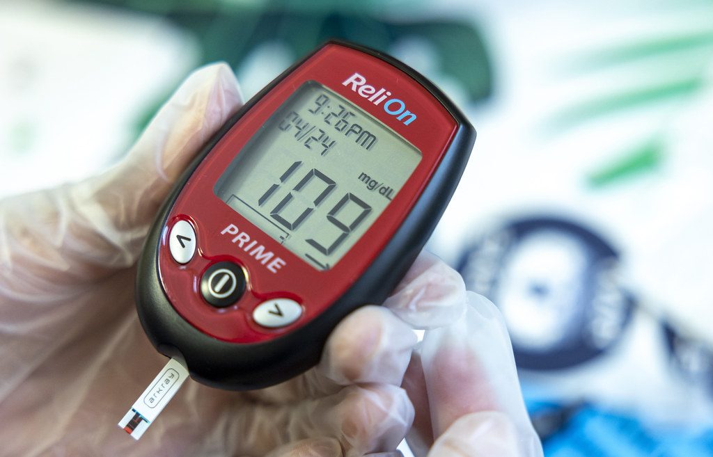 A blood glucose meter showing a reading