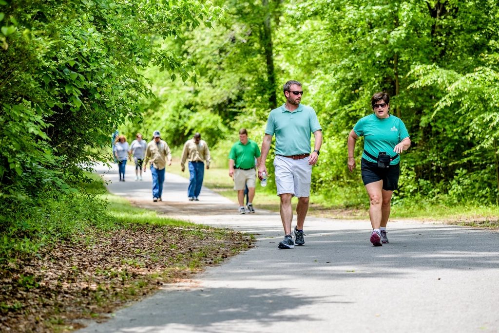 People walking on a path through a park