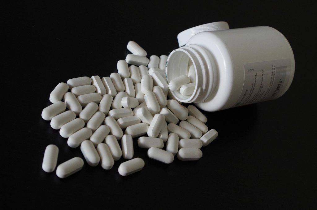 White pills spilling from a bottle