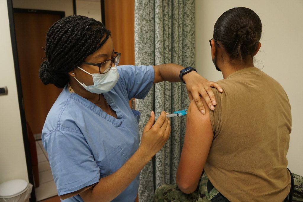 A nurse giving a vaccine in a patient’s arm